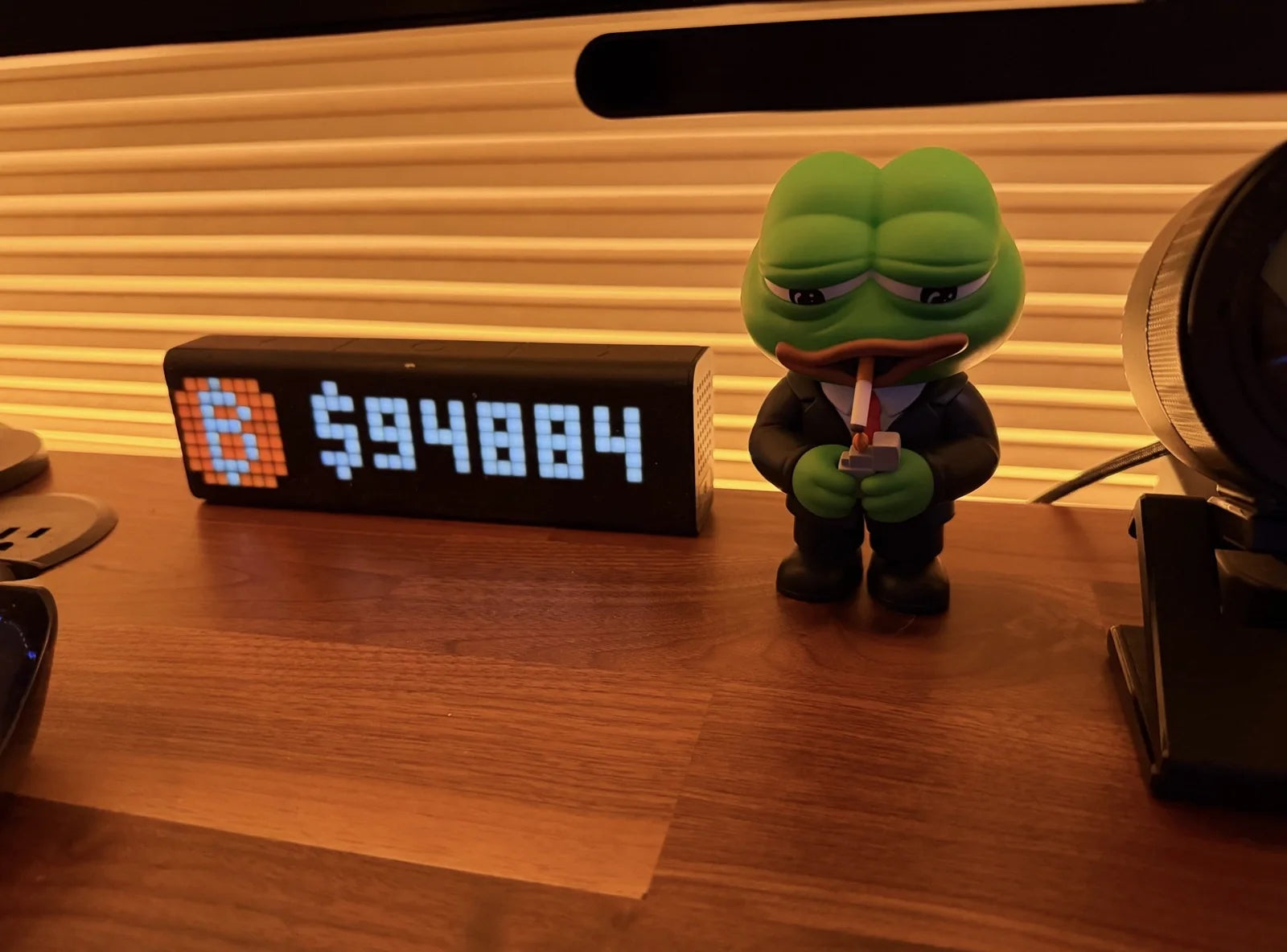 Savvy Desk Fren beside a Bitcoin price display on a desk